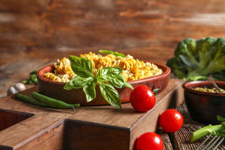 Plate with tasty pasta and pesto sauce on wooden tableの写真素材
