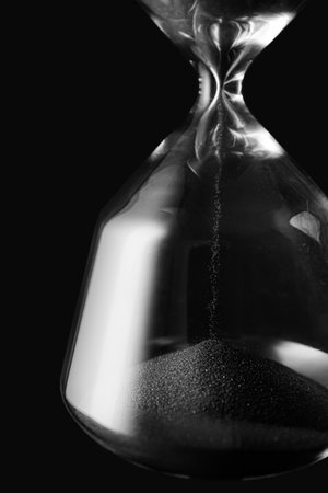 Crystal hourglass on dark background, closeupの写真素材