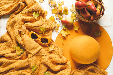 Beautiful autumn composition with warm clothes on light wooden backgroundの写真素材