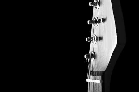 Black and white photo of modern guitar against dark background, closeupの写真素材