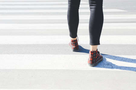 Young woman crossing road. Concept of choiceの写真素材