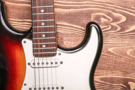 Modern bass guitar on wooden background, closeupの写真素材