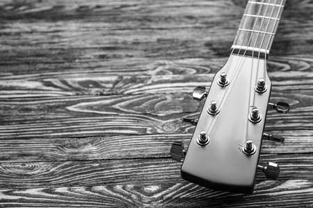 Black and white photo of modern guitar on wooden backgroundの写真素材
