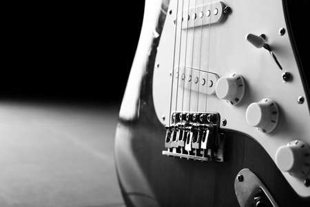 Black and white photo of modern bass guitar, closeupの写真素材