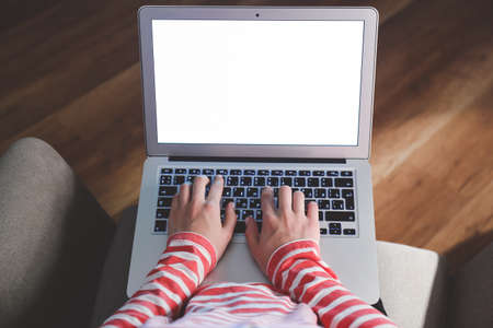Young woman working on laptop late in eveningの写真素材