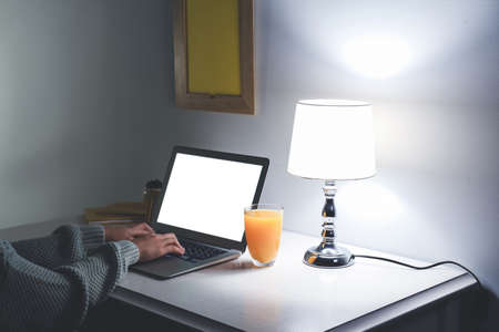 Young woman working on laptop late in evening