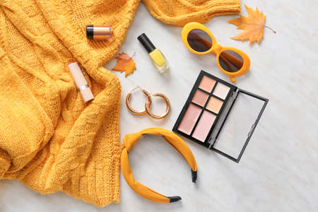 Sweater, set of decorative cosmetics and accessories on light backgroundの写真素材