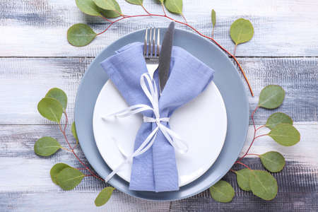 Beautiful table setting with eucalyptus on wooden backgroundの写真素材