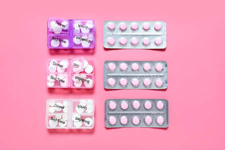 Pills and containers on color backgroundの写真素材