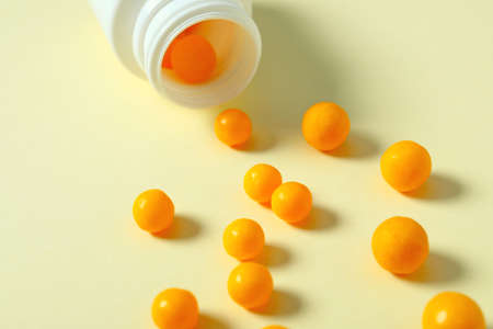 Jar and scattered pills on color background, closeupの写真素材