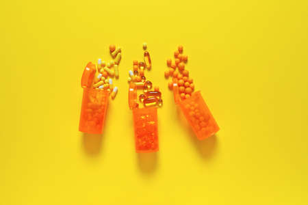 Jars with different pills on color backgroundの写真素材