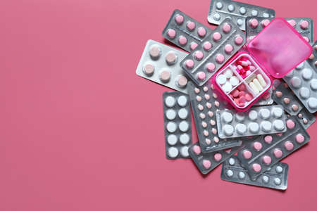 Many different pills on color background