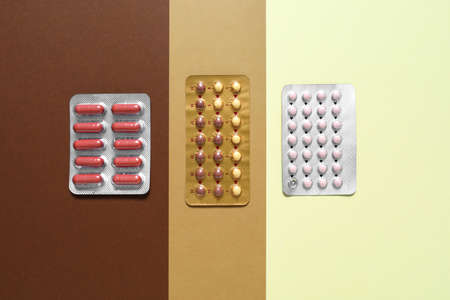 Different pills on color background