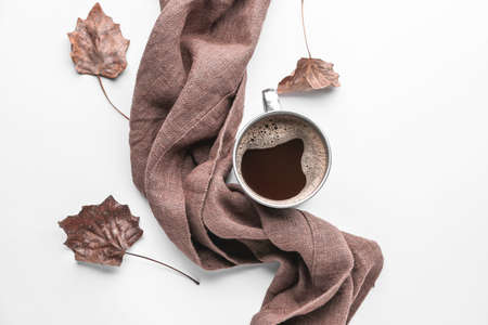 Composition with scarf, cup of coffee and autumn leaves on white backgroundの写真素材