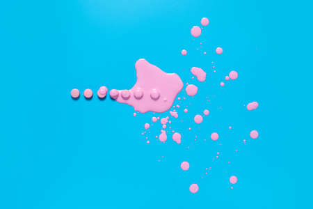 Pills and spilled paint on color background
