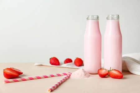 Bottles of strawberry protein shake on white tableの写真素材