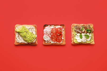 Tasty sandwiches on color background