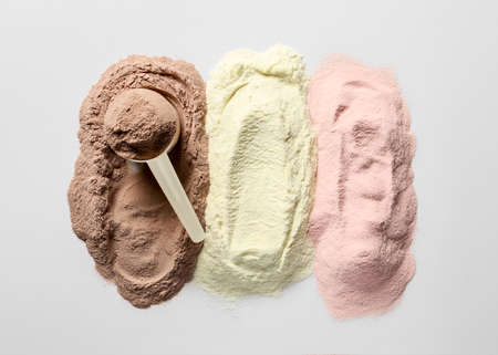 Different protein powders on white background