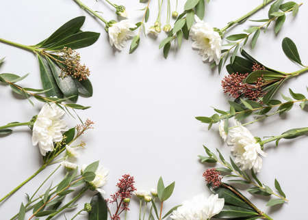 Composition with autumn flowers and leaves on white background