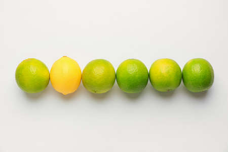 Ripe lemon and limes on white backgroundの写真素材