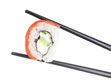 Chopsticks with tasty sushi roll on white backgroundの写真素材