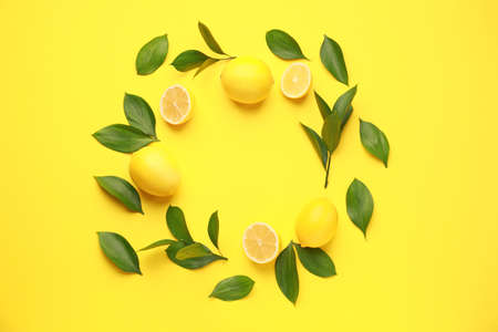 Frame made of ripe lemons on color backgroundの写真素材