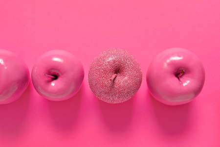 Apples on color background. Concept of uniquenessの写真素材