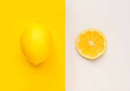 Ripe lemon and slice on color backgroundの写真素材