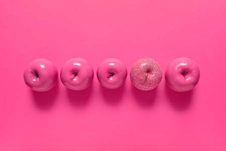 Apples on color background. Concept of uniquenessの写真素材