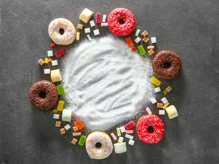 Sugar and different sweets on gray backgroundの写真素材
