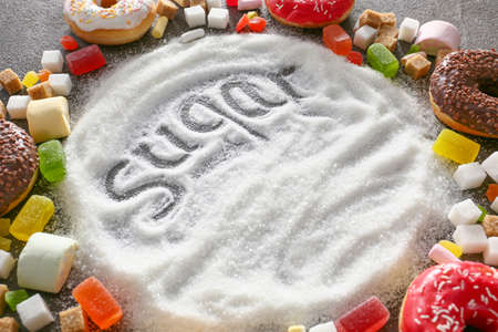 Sugar and different sweets on gray backgroundの写真素材