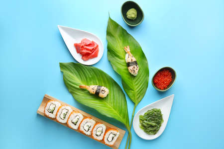 Composition with tasty sushi on color backgroundの写真素材