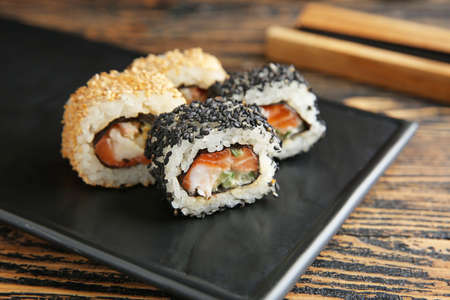 Plate with tasty sushi rolls on table, closeupの写真素材