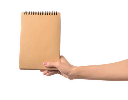 Female hand with notebook on white backgroundの写真素材