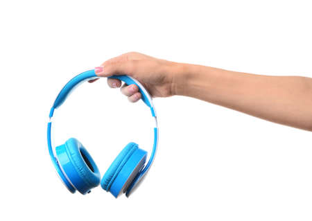 Female hand with headphones on white backgroundの写真素材