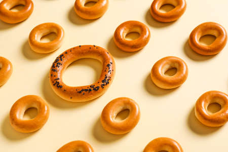 Big cracknel among small ones on light background. Concept of uniqueness