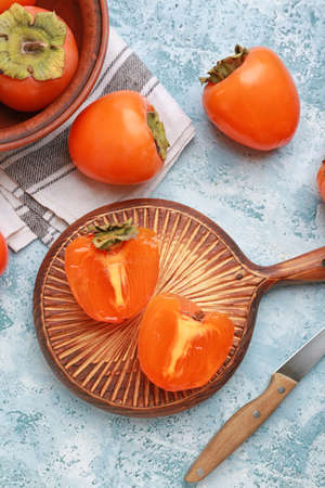 Composition with ripe persimmons on tableの写真素材