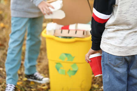 Little children collecting trash outdoors. Concept of recyclingの写真素材
