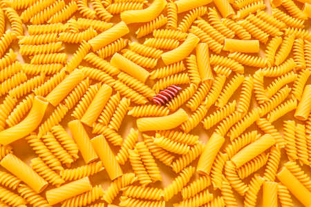 One pink pasta among others. Difference and uniqueness conceptの写真素材