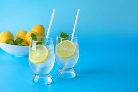 Glasses of fresh lemonade on color backgroundの写真素材