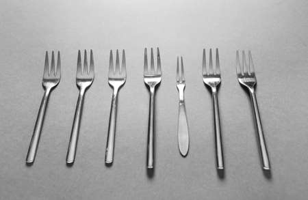 Different forks on gray background. Uniqueness conceptの写真素材
