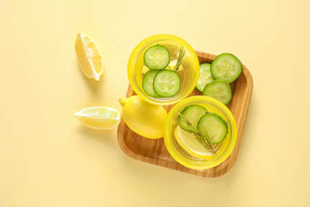 Glasses of cold cucumber water on light backgroundの写真素材