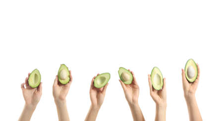 Female hands with fresh avocados on white background