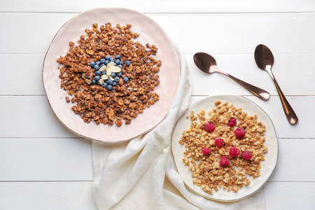 Plates with tasty granola on tableの写真素材