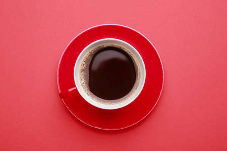 Cup of hot coffee on color backgroundの写真素材