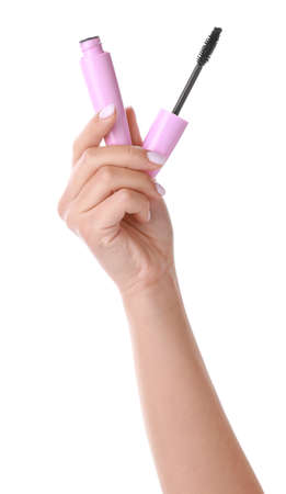 Female hand with mascara on white backgroundの写真素材
