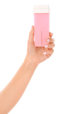 Female hand with liposoluble wax cartridge for epilation on white backgroundの写真素材