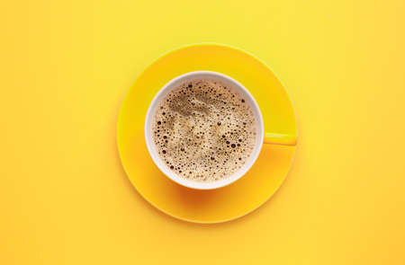 Cup of hot coffee on color backgroundの写真素材