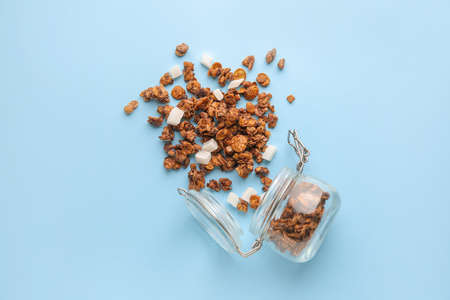 Jar with tasty granola on color backgroundの写真素材