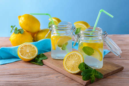 Mason jars of fresh lemonade on wooden tableの写真素材